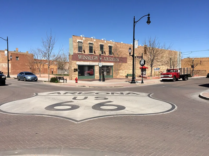Arizona US 66 shield painted on the road at Standin' on the Corner Park, Winslow