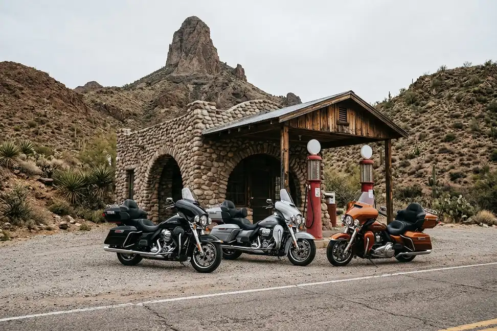 Three touring motorcycles beside the stone Cool Springs station on Route 66 in Arizona